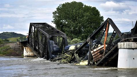 Freight train carrying hazardous materials plunges into Yellowstone River as bridge fails